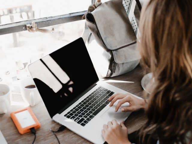 woman posting on her laptop