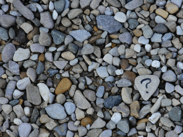 assorted rocks with a question mark placed on one